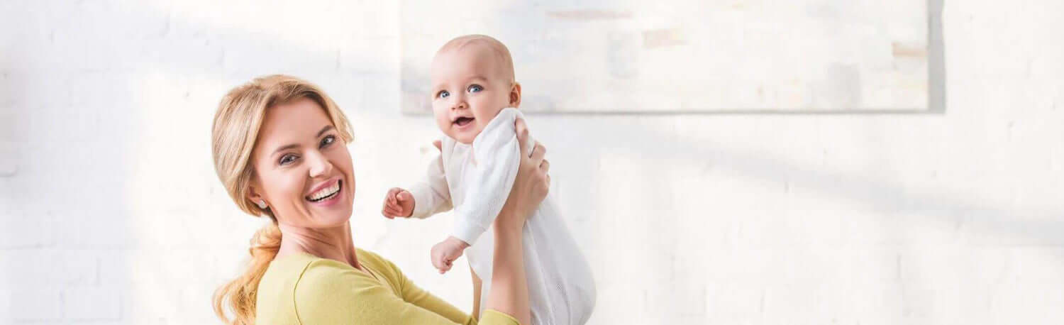 happy mother holding her baby and smiling