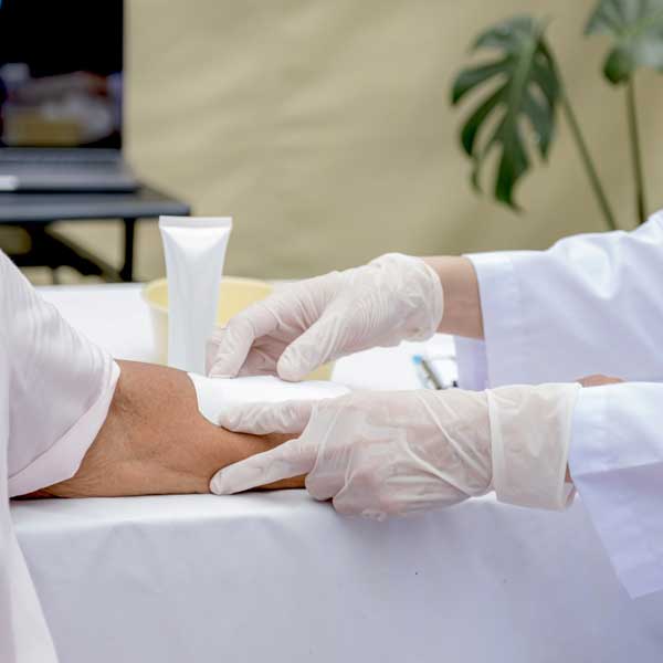 Image of Nurse applying wound care bandage