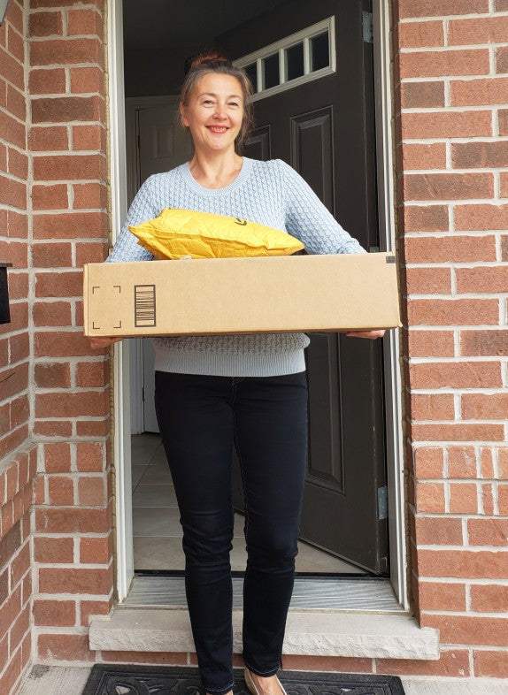 happy female customer with her package from Cart Health
